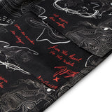 Black fabric with white and red text and patterns
